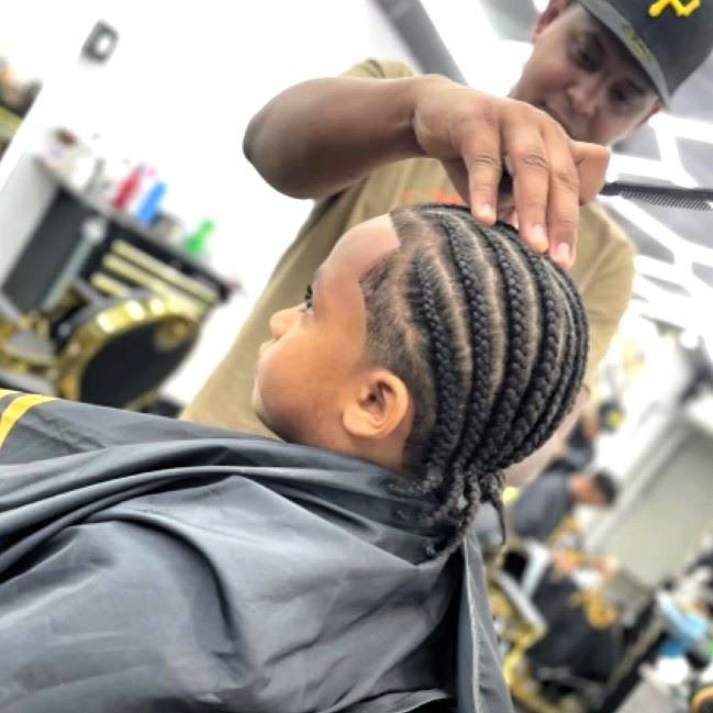 barber with kid in braids